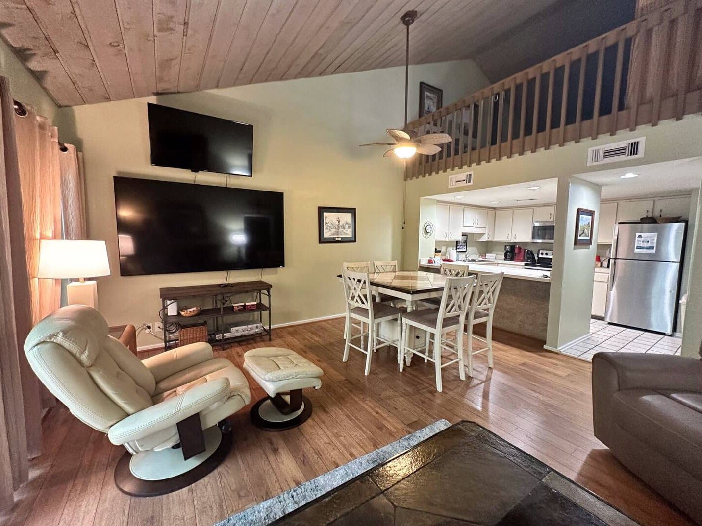 Full view of living space with kitchen and loft
